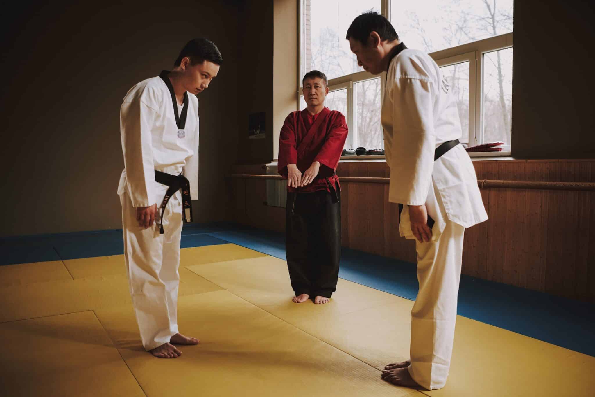 Martial Arts Training between two students with the instructor watching
